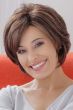 Woman in a long layered light brown pixie wig with side bangs
