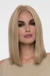 Woman in a blunt cut shoulder length dark blonde wig