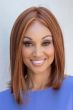 Woman in a blunt cut shoulder length dark blonde wig