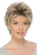 Woman in a long teased dark blonde pixie wig with fringe bangs
