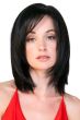 Woman in a shoulder length straight black wig with long layers and side bangs