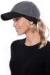 Woman in headband with ponytail attached worn under a baseball cap