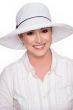 Woman in white wide brimmed ribbon braid sun hat
