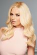 Woman in an extra long light blonde wavy wig