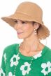 Woman in outdoor toyo straw summer sun hat with brim, crocheted trim detail and back flower