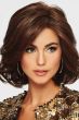 Woman in a shoulder length volume-infused curly dark brown bob wig