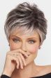 Woman in a tousled light grey pixie wig with dark roots