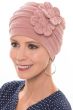 Woman in beanie style pink chemo hat with 2 side flowers