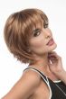 Woman in a shoulder length choppy light auburn bob wig with fringe bangs