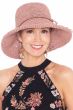Woman in pink woven summer sun hat for cancer patients
