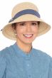 Woman in cute straw women's bucket hat with blue denim band accent and sash for cancer patients