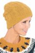 Woman in marigold colored beanie hat with cable knit stitching