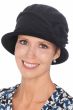 Woman in black cotton knitted cloche hat for cancer patients with side flower