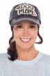 Woman in black distressed baseball cap with "Dog Mom" patch on front