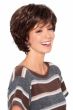 Woman in brown medium length layered wig with bangs and waves