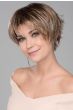 Woman in a long blonde pixie wig with dark roots and short spiky hair in back