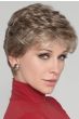 Woman in an evenly layered curly light blonde lace front pixie wig