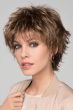 Woman in a long shaggy medium brown pixie wig with wispy bangs