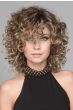 Woman in a full layered, curly light brown shoulder length wig