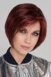Woman in an angled dark red chin length bob wig with face framing layers