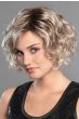 Woman in an angled chin length curly ash blonde lace front wig