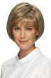 Woman in a chin length light brown rounded bob wig with textured bangs