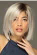 Woman in a shoulder length platinum blonde razor cut lace front wig