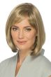 Woman in a past chin length light brown blunt bob with side curtain bangs