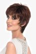 Woman in a long dark auburn feathered pixie wig with fringe bangs and longer hair at the nape