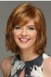 Woman in a chin length light auburn wig with side bangs