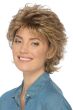 Woman in a volume infused short layered warm blonde wig