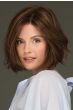Woman in a chin length wavy medium auburn lace front bob wig