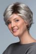 Woman in a long layered light grey pixie wig with side bangs and dark roots