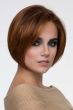 Woman in a chin length medium auburn rounded bob wig