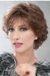 Woman in a short layered medium auburn curly wig with bangs