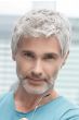 Man in a short tousled white lace front wig with longer hair on top