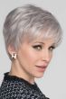 Woman in a light grey lace front pixie wig with fringe bangs