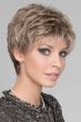 Woman in an evenly layered light brown curly lace front pixie wig