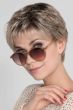 Woman in a cropped classic ash blonde pixie wig with fringe bangs