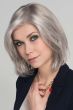 Woman in a light grey shoulder length blunt bob wig with face framing layers