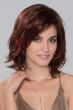 Woman in a shoulder length deep red layered bob wig with side bangs