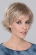 Woman in a light blonde pixie wig with longer hair on top and side bangs