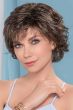 Woman in a chin length heavily layered brown and grey curly bob wig
