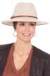 Woman in beige wool festival hat with wide brown headband underneath to provide full head coverage for cancer patients