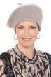 Woman in light taupe winter beret with shimmer and zig zag accents