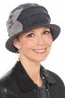 Woman in 2 tone dark grey winter wool felt cloche hat with pleats on crown and light grey felt flower on the side