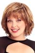 Woman in a past the chin medium auburn layered curly wig with fringe bangs