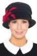 Woman in black cloche style winter fleece cancer hat with red accents and flower