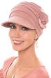 Woman in pink cancer hat with front brim, pleats and side flower