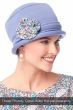 Woman in a denim Cotton Roller Hat with a multi-paisley bamboo flower pin attached